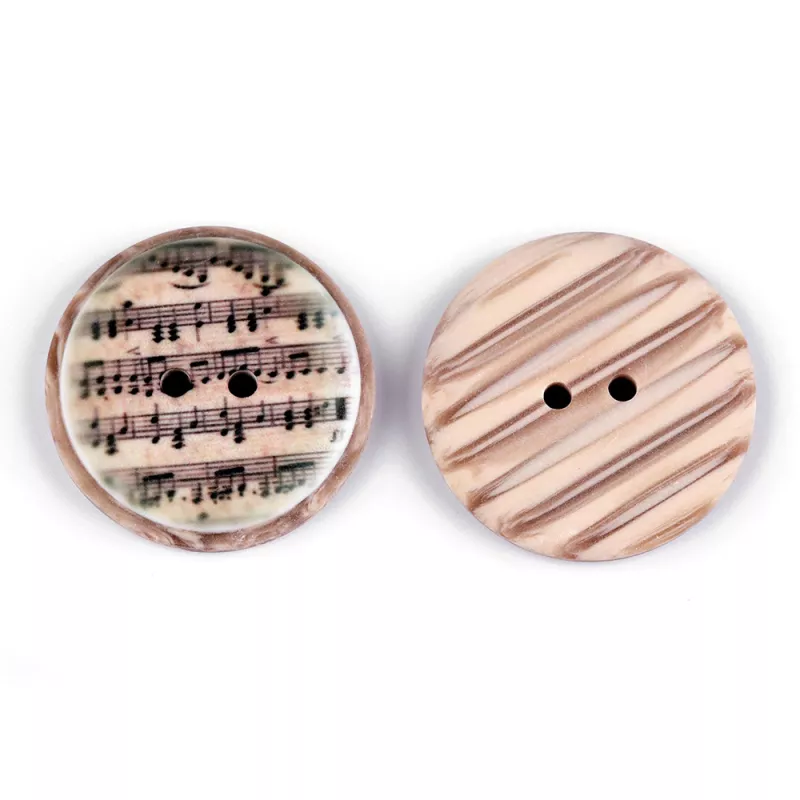 Knoflík plastový béžový s černými notami 25 mm